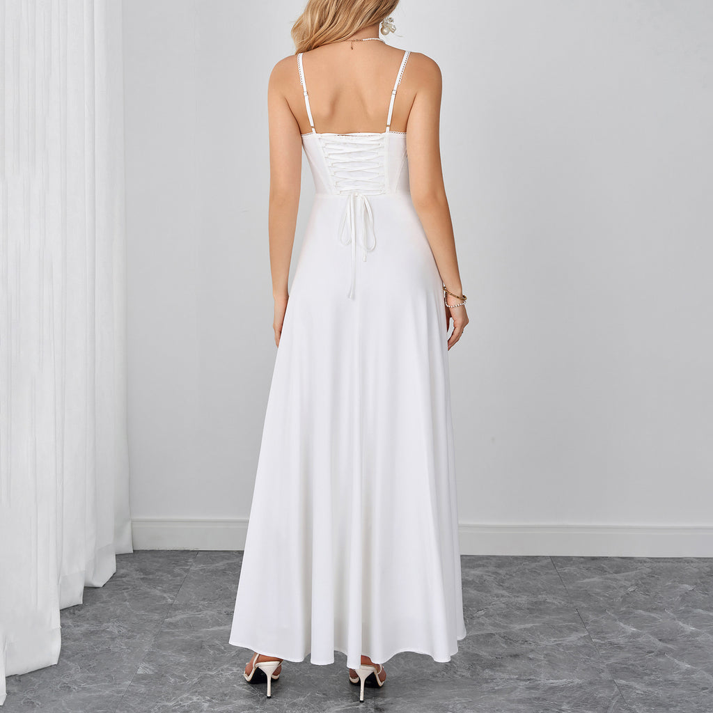 White backless maxi dress with spaghetti straps and gathered waist detail.