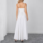 White backless maxi dress with spaghetti straps and gathered waist detail.