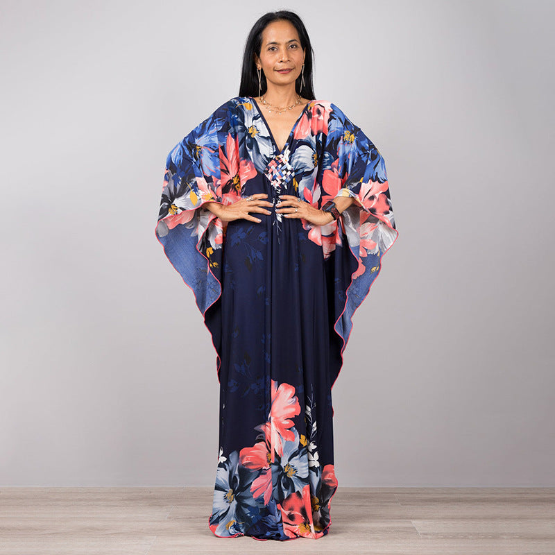 One-piece beach dress in navy with pink and orange floral print and wide sleeves