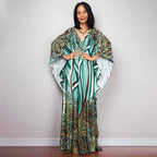 One-piece beach dress with teal and green palm-feather print and V-neck drape