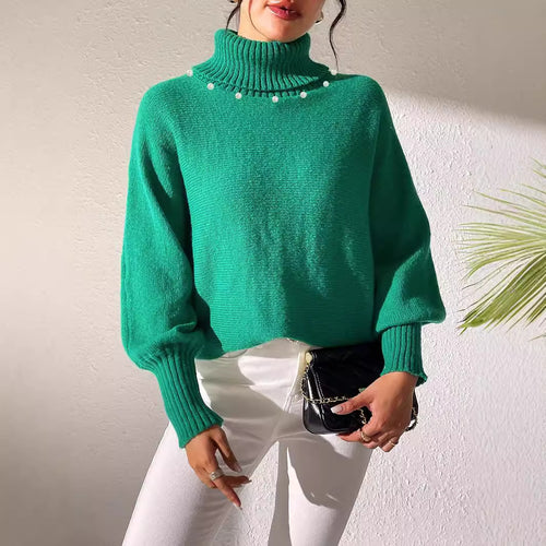 Women’s green turtleneck sweater with pearl bead embellishment at the neckline