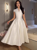White short-sleeve V-neck fit-and-flare dress with pleated full skirt