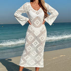 White fitted midi dress with deep V-neck, long sleeves, and diamond-patterned knit