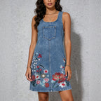 Blue denim sleeveless sling dress with square neckline, front pocket, floral embroidery skirt