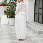 White one-piece swimwear, long sleeves, tiered ruffle front and skirt