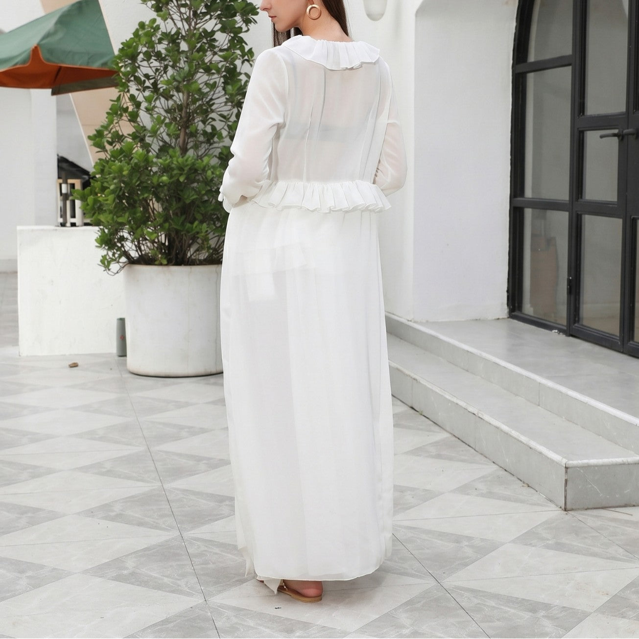 White one-piece swimwear, long sleeves, tiered ruffle front and skirt