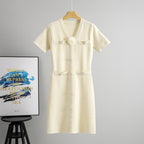 Apricot midi knit dress with V-neck, short sleeves, button front and flower applique