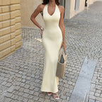 Cream sleeveless halter maxi dress with long column skirt and low V-neck