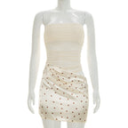 Apricot strapless mini dress with brown polka dots, ruched bodice and fitted skirt