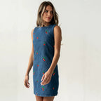 Blue denim sleeveless vest with red and green embroidery, front view, short straight hem