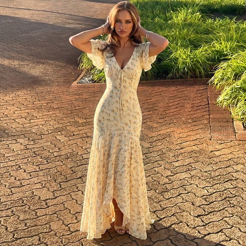 Cream floral maxi dress with V-neck and flutter sleeves, fitted waist and side slit hem