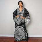 One-piece beach swim dress with V-neck and draped sleeves, black-and-white ornate pattern