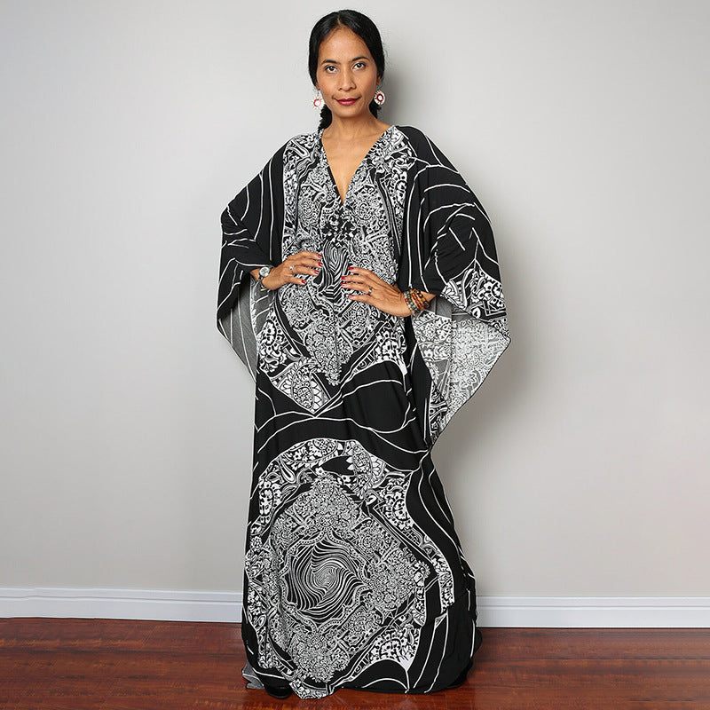 One-piece beach swim dress with V-neck and draped sleeves, black-and-white ornate pattern