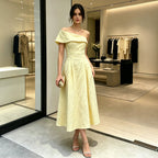 Yellow off-shoulder backless midi dress with fitted waist and flared skirt