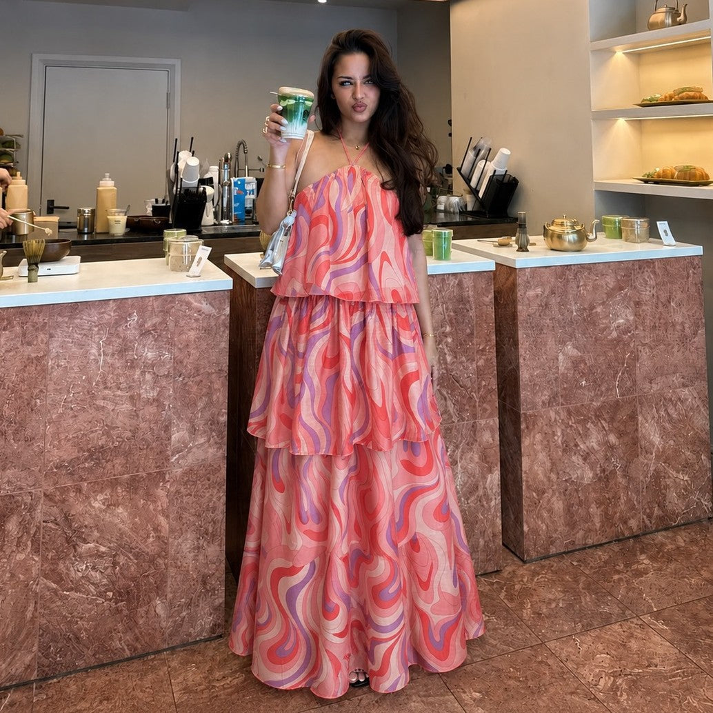 Women's halter tiered maxi dress in coral pink with abstract swirl pattern