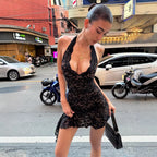 Black lace halter mini dress with deep V neckline and scalloped hem