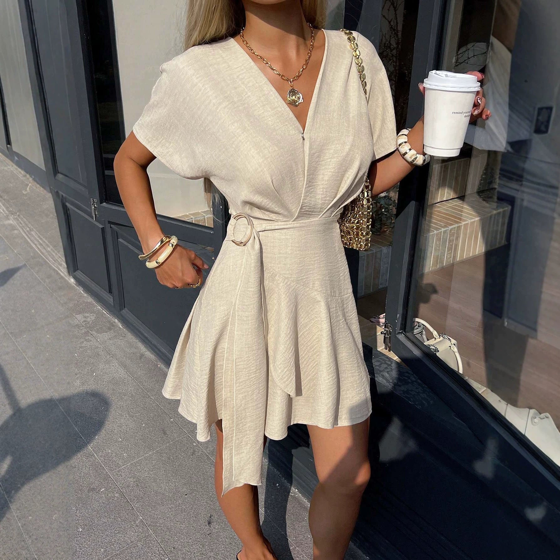 Light beige belted V-neck mini dress with short sleeves and flared hem
