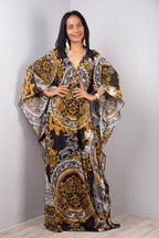 Black beach dress one-piece swimwear with gold and white ornate pattern and flowing sleeves