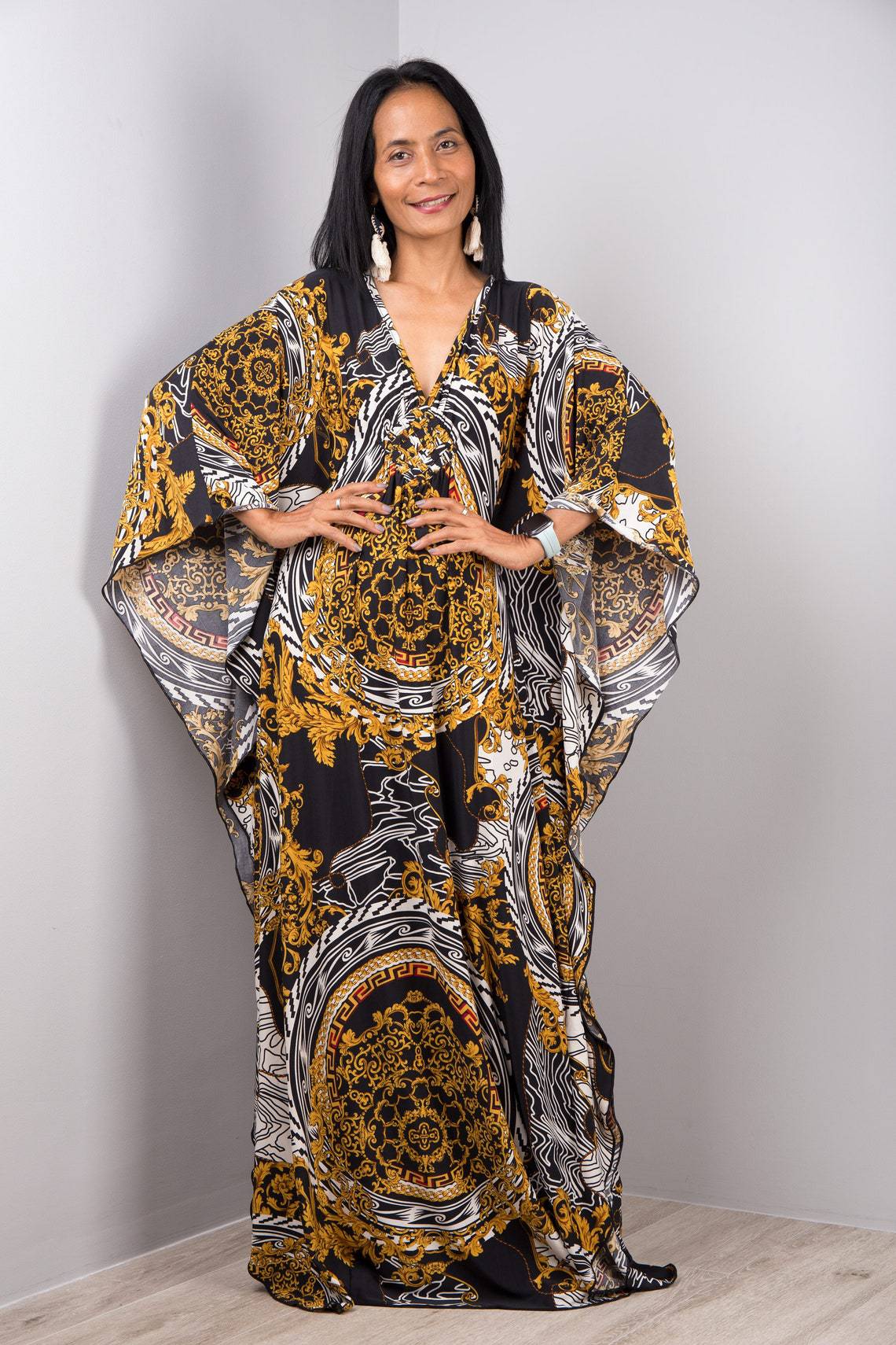 Black beach dress one-piece swimwear with gold and white ornate pattern and flowing sleeves