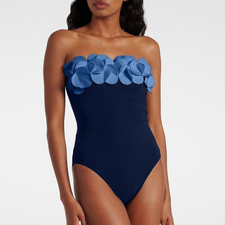 One-piece swimsuit with strapless light-blue ruffle flower detail, dark navy