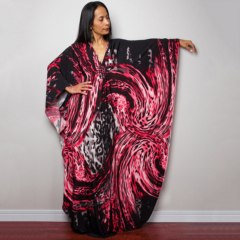 Black with bright pink and red swirl-print one-piece swim dress with V-neck