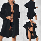 Black button-up swim cover-up tunic over black one-piece swimsuit with deep V neckline
