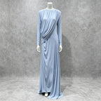 Light blue pleated formal dress with long sleeves, diagonal drape detail, full-length skirt