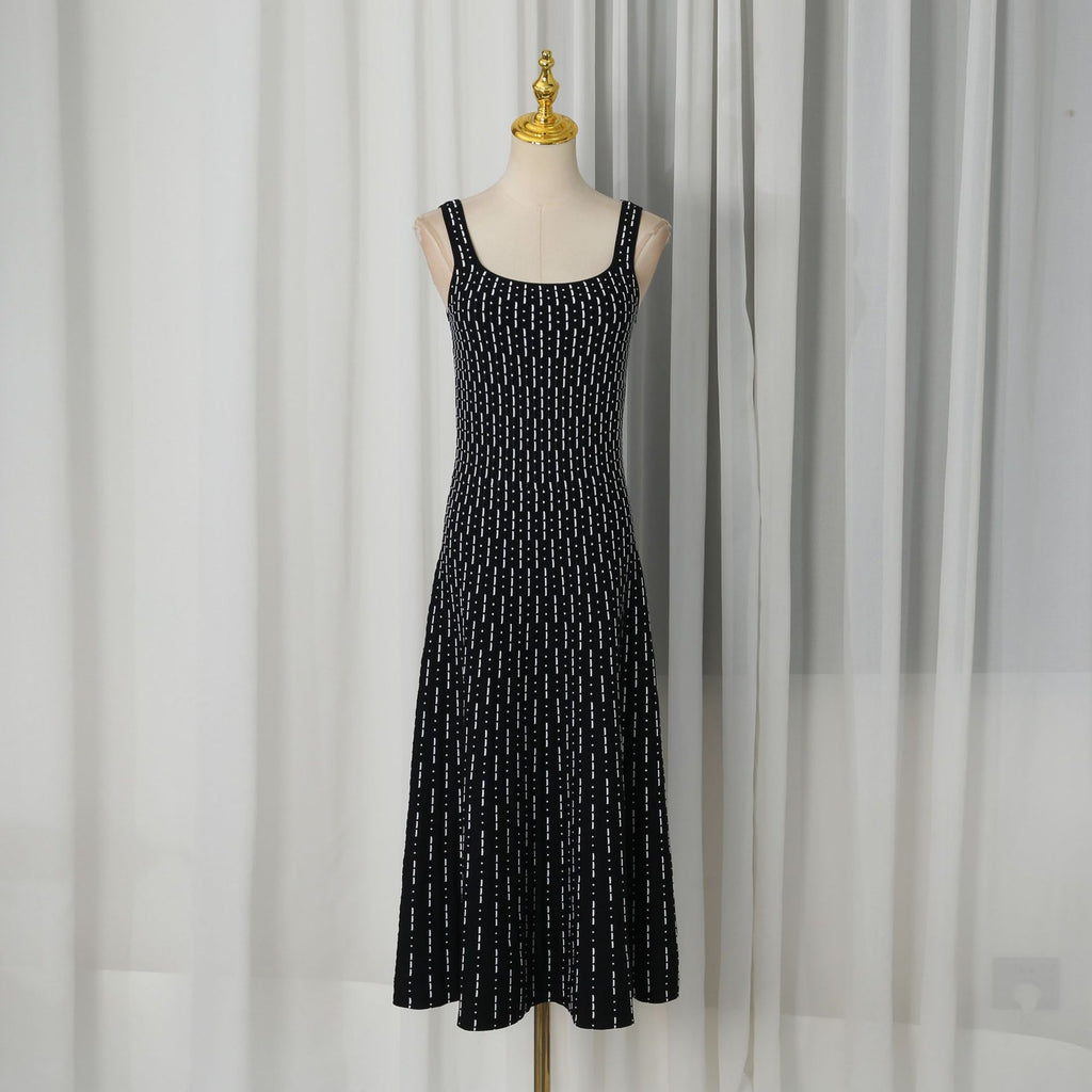 Black sleeveless maxi dress on mannequin with scattered white dot pattern, scoop neck