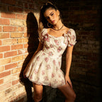 Floral lace mini dress with puff sleeves, square neckline, and pink print on cream base