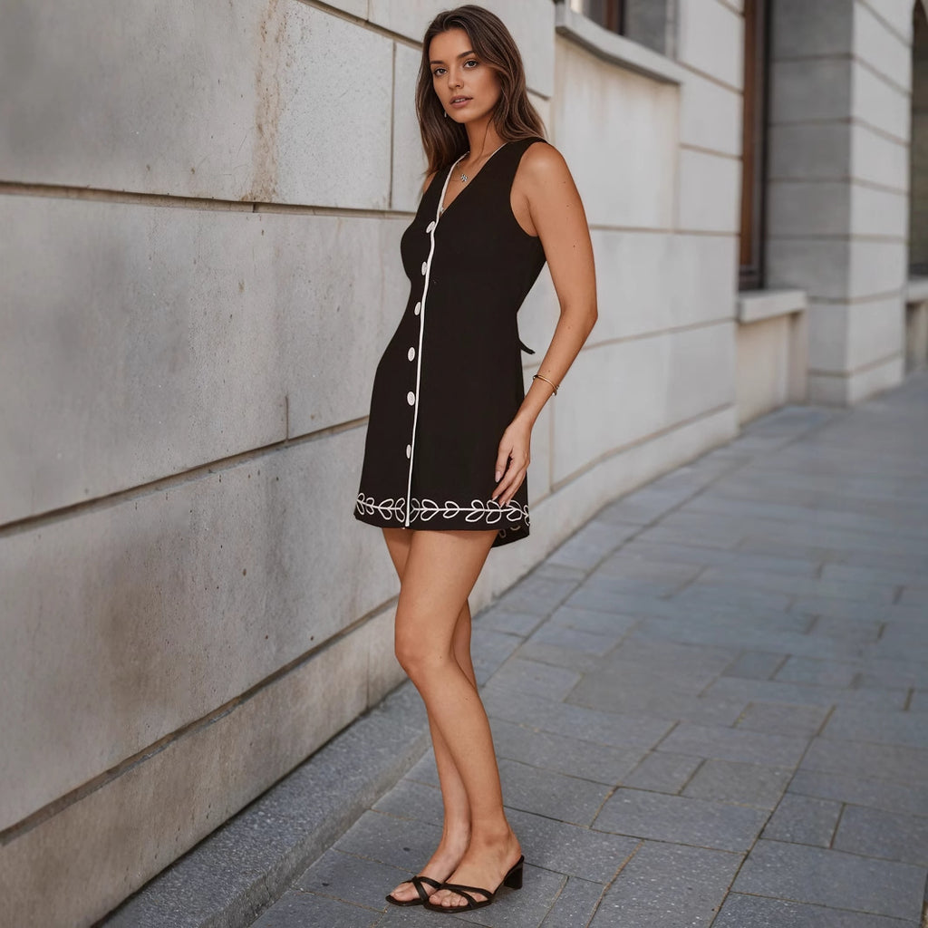 Black sleeveless mini dress with button front and scalloped trim hem