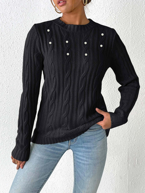 Black cable knit sweater with round neck and pearl beaded button details