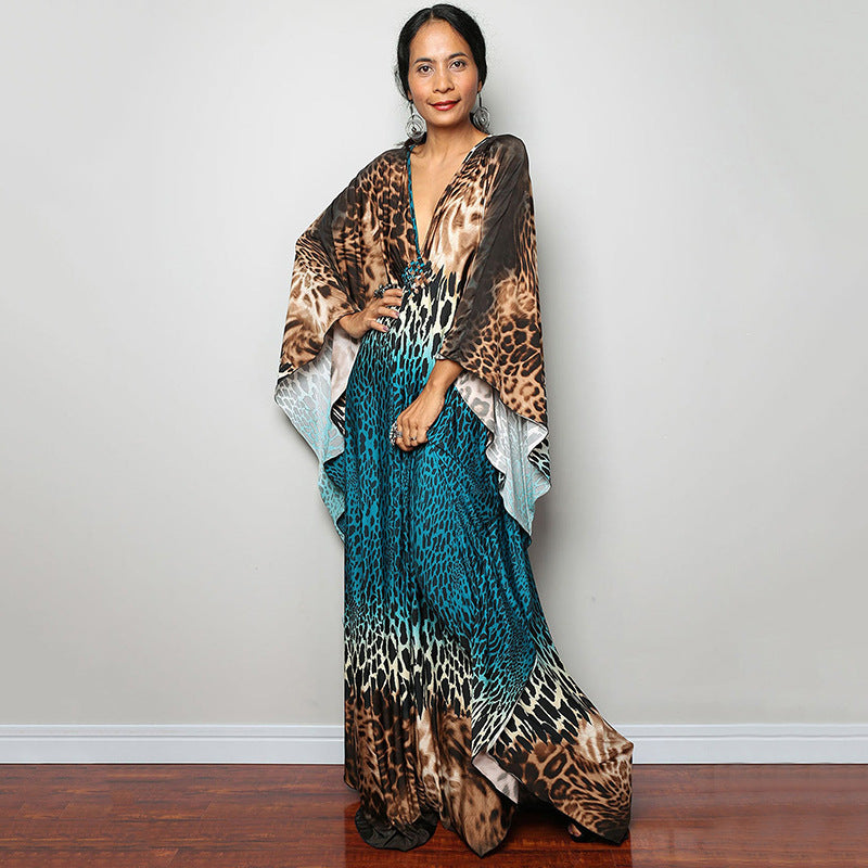 Brown and teal animal-print one-piece swim dress with V-neck and flowing sides
