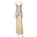 Gold backless sling dress on mannequin with spaghetti straps and draped long hem