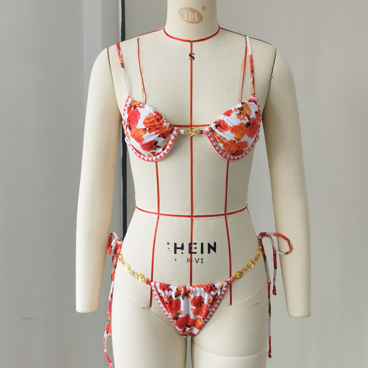 Floral one-piece swimsuit with tie straps, underwire cups, and gold-tone trim