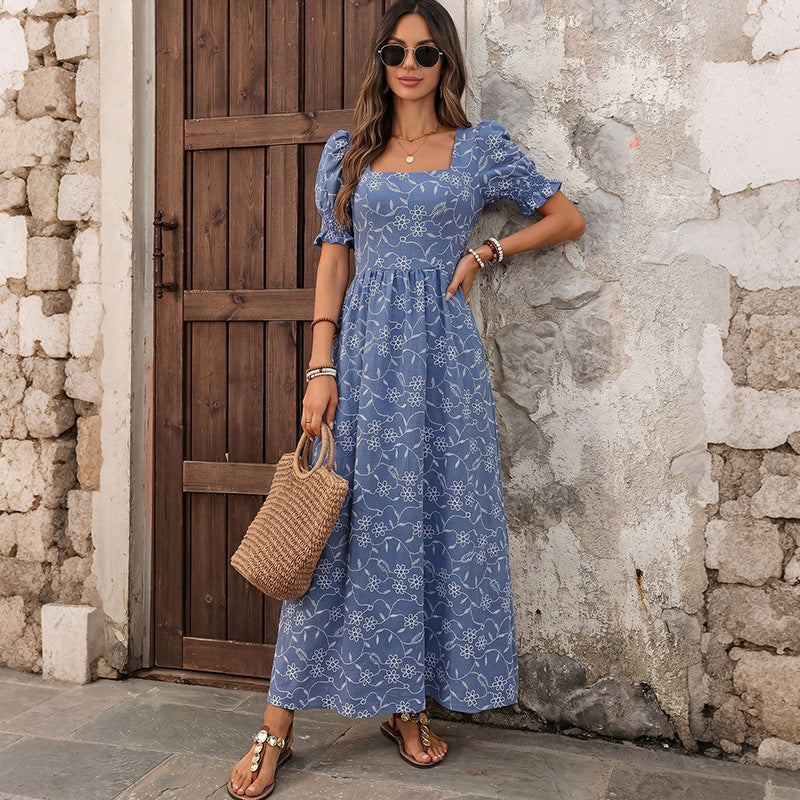 Blue floral midi dress with square neckline, puff sleeves, and tiered skirt