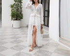 White one-piece swimwear with flowing tiered ruffles and long sleeves