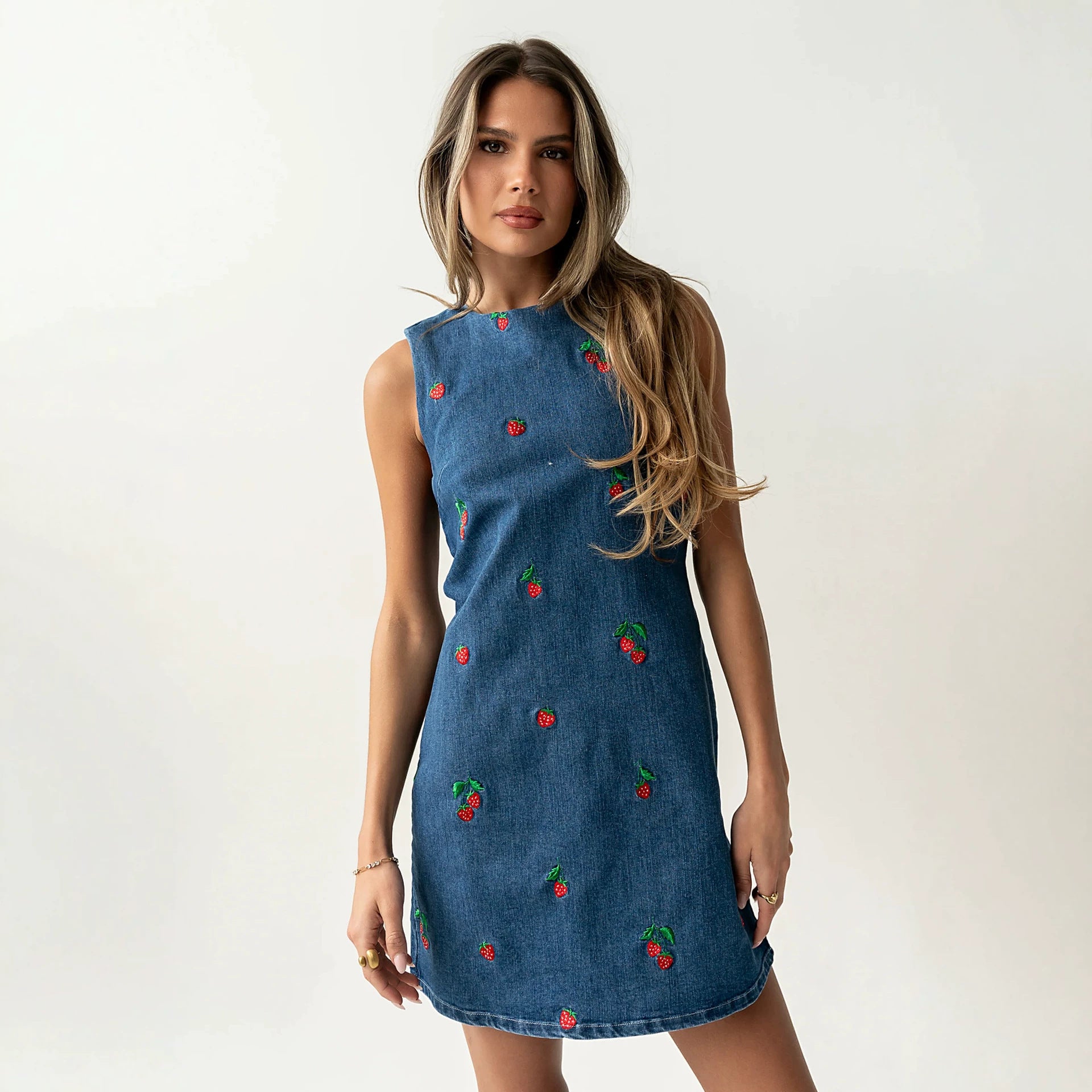 Blue denim sleeveless vest with red and green embroidery, relaxed straight hem