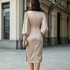 Women's satin midi dress in champagne, long puff sleeves, back seam, fitted waist.