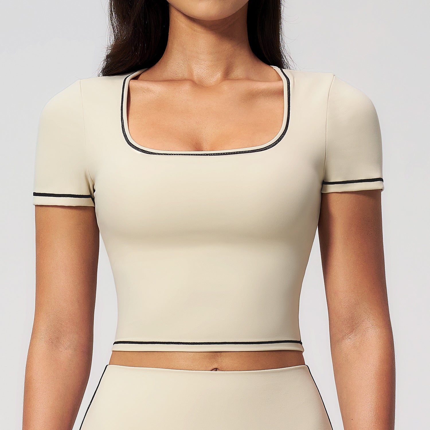 Cream cropped sports top with contrast trim and short sleeves