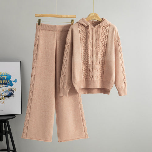 Pink hooded cable-knit sweater and wide-leg pants set on hanger