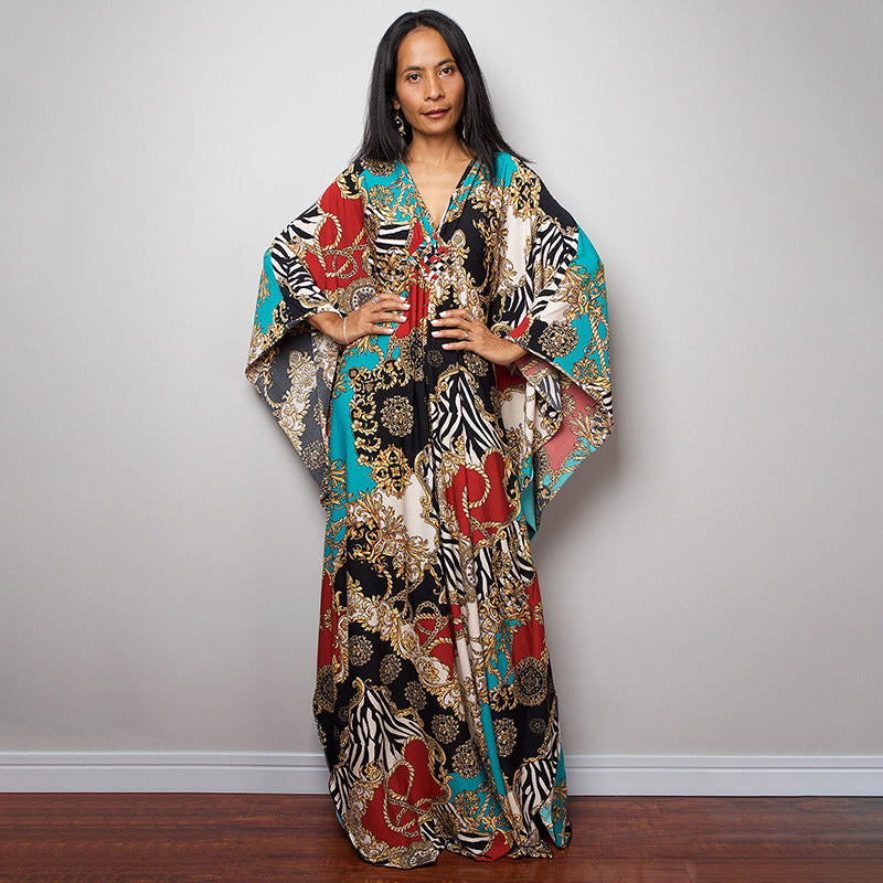 Colorful patterned one-piece swim dress with V-neck and flowing wide sleeves