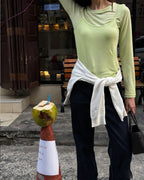 Light green long-sleeve top with faux camisole overlay and side tie hem detail