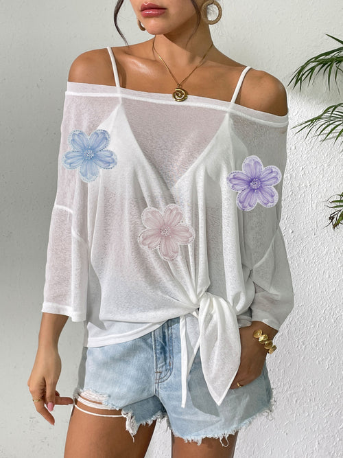 White beach cover-up with off-shoulder neckline, tie-front knot, and lilac/blue/pink flower appliques