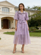 Purple maxi dress with short puff sleeves, button front, lace accents, and sash belt