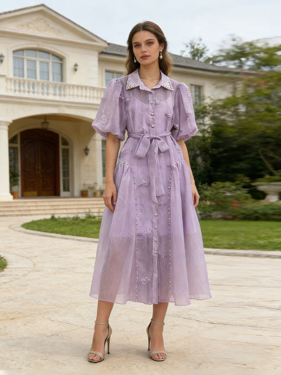 Purple maxi dress with short puff sleeves, button front, lace accents, and sash belt