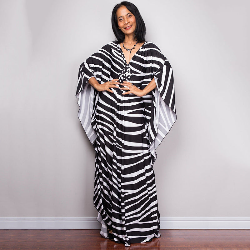 One-piece beach dress with black-and-white zebra stripes and loose kaftan sleeves