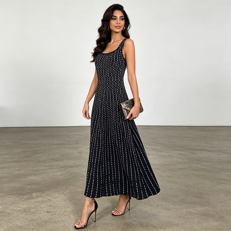 Black sleeveless maxi dress with scattered white dot pattern, scoop neckline