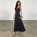 Black sleeveless maxi dress with scattered white dot pattern, scoop neckline