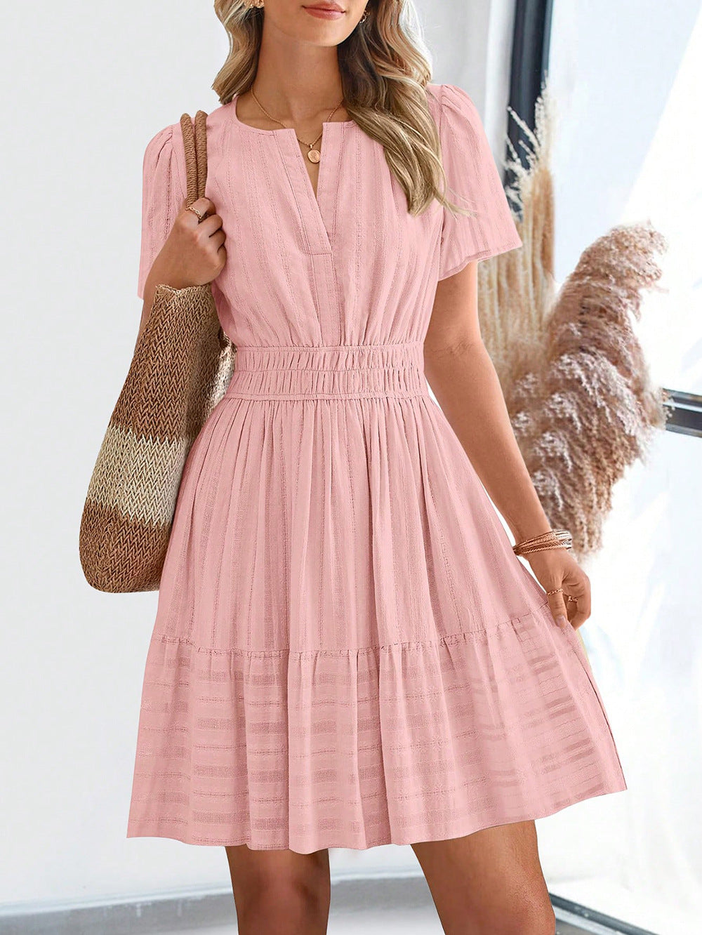 Light pink short-sleeve summer dress with V-neck and tiered skirt