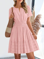 Light pink short-sleeve summer dress with V-neck and tiered skirt
